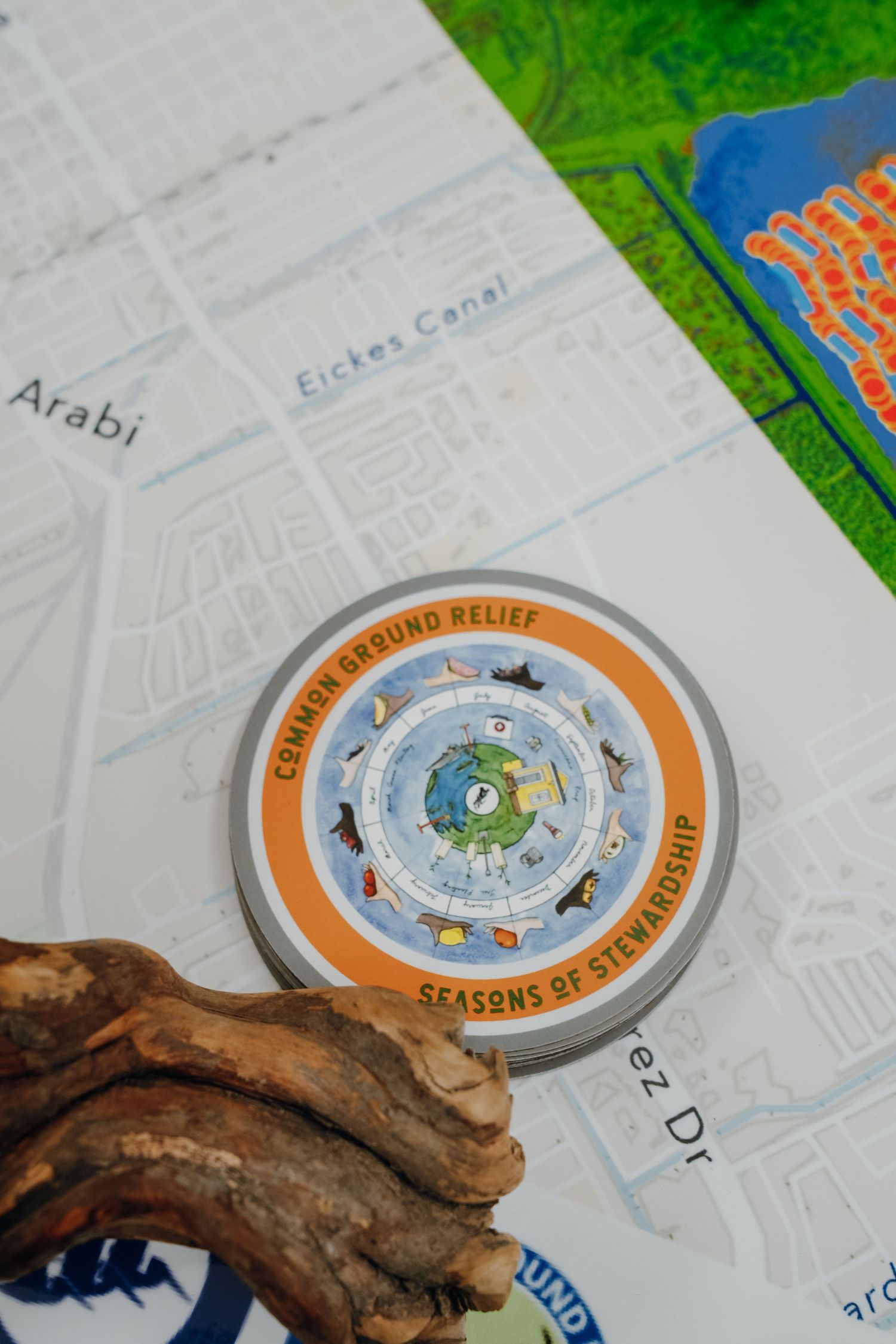 Common Ground Relief Seasons of Stewardship circular guide displayed on a map near Arabi and Eickes Canal.