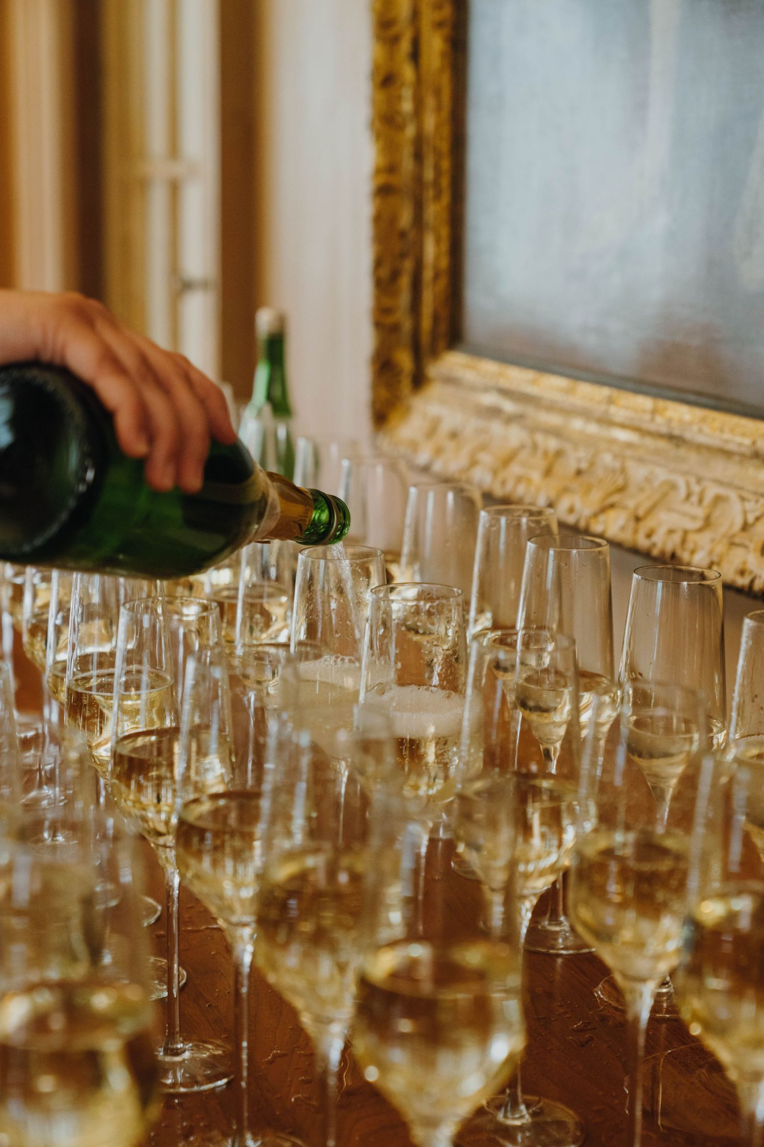 Champagne being poured into elegant flute glasses arranged on a table at an event. New Orleans, Louisiana, Mississippi