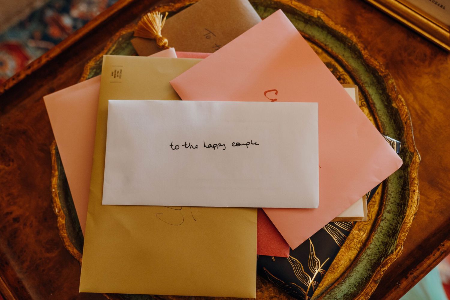 Wedding envelopes in pink, gold, and white with to the happy couple written on top. New Orleans, Louisiana, Mississippi