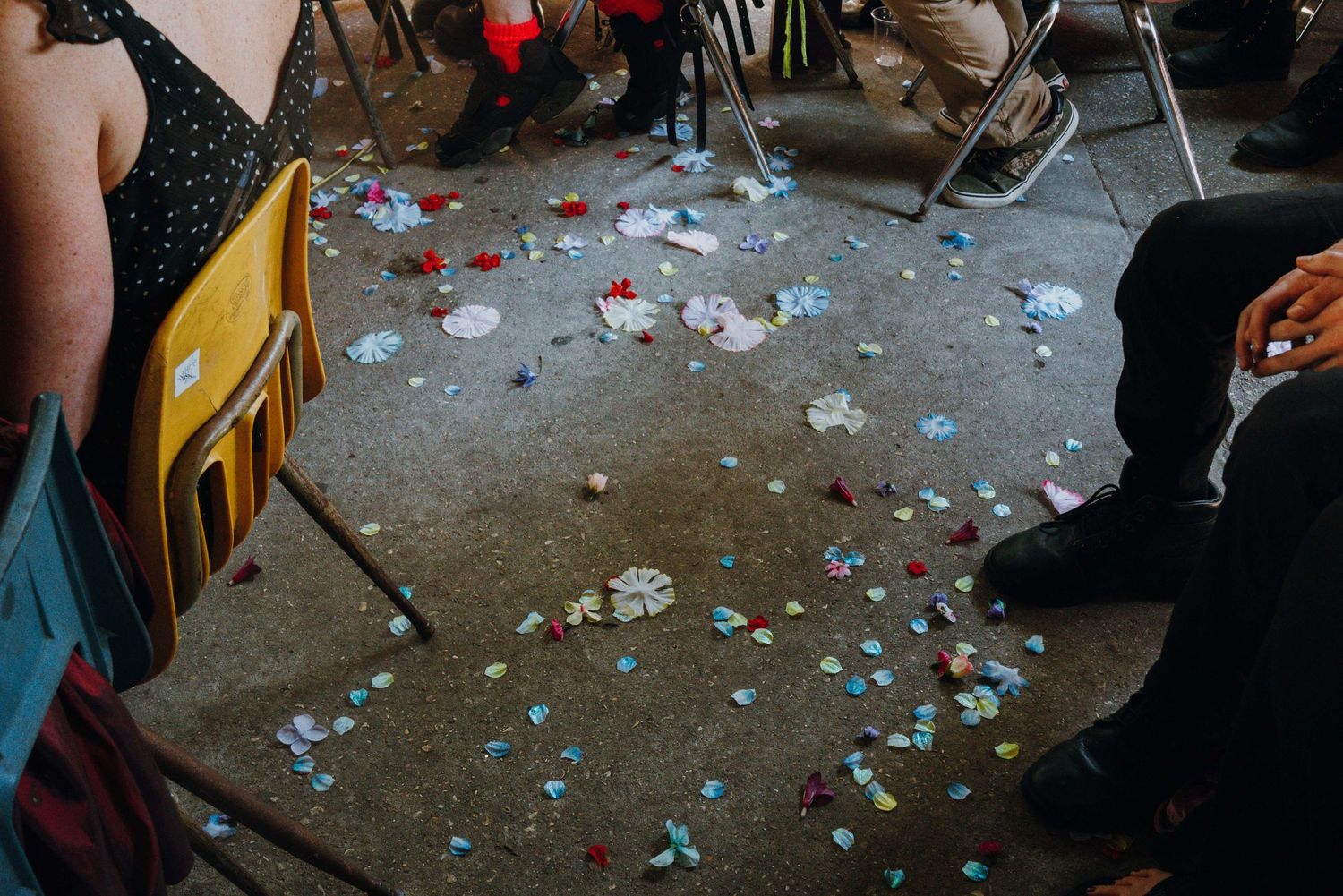 Colorful confetti scattered on a concrete floor at a baby shower celebration.