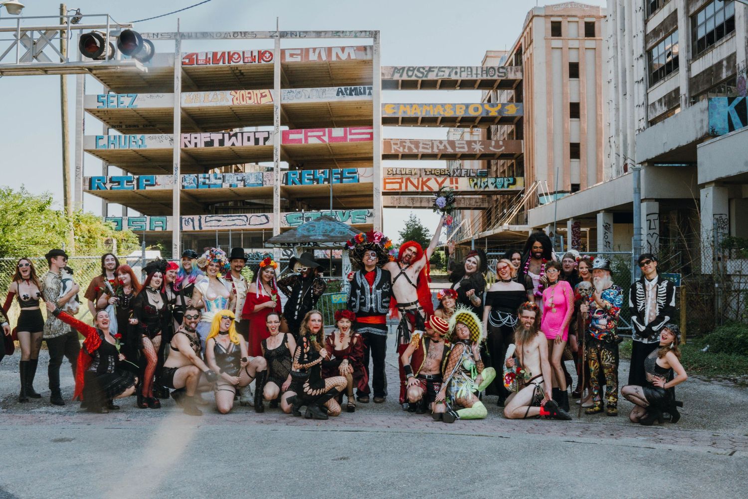 colorful digital photo of a wedding party matrimony homies  group photo in elaborate wedding costume attire at an outdoor dive bar wedding