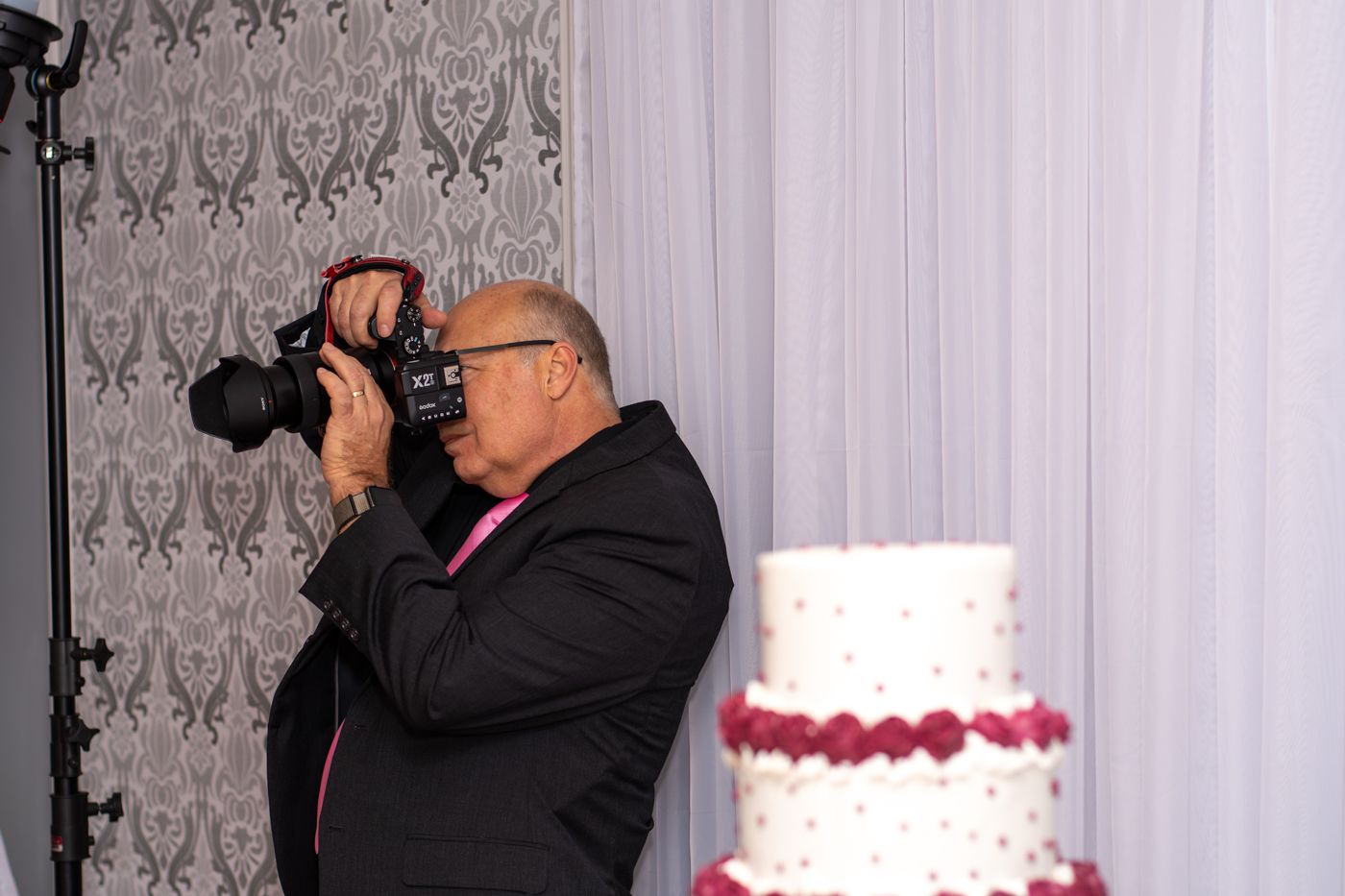 Michael taking a photo at a wedding reception.