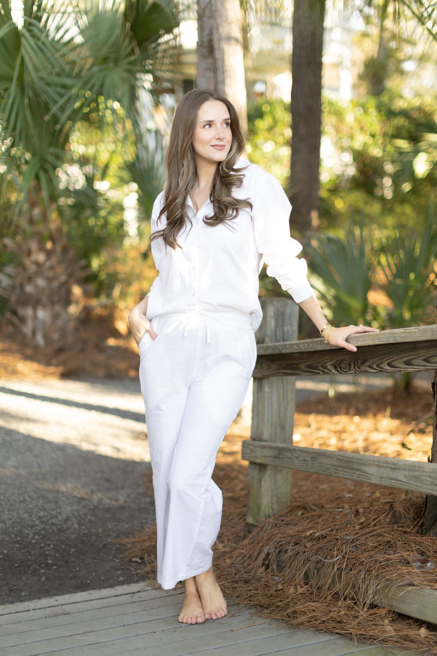 A series of outdoor portraits in a white dress against a natural backdrop with palm trees and fallen leaves.