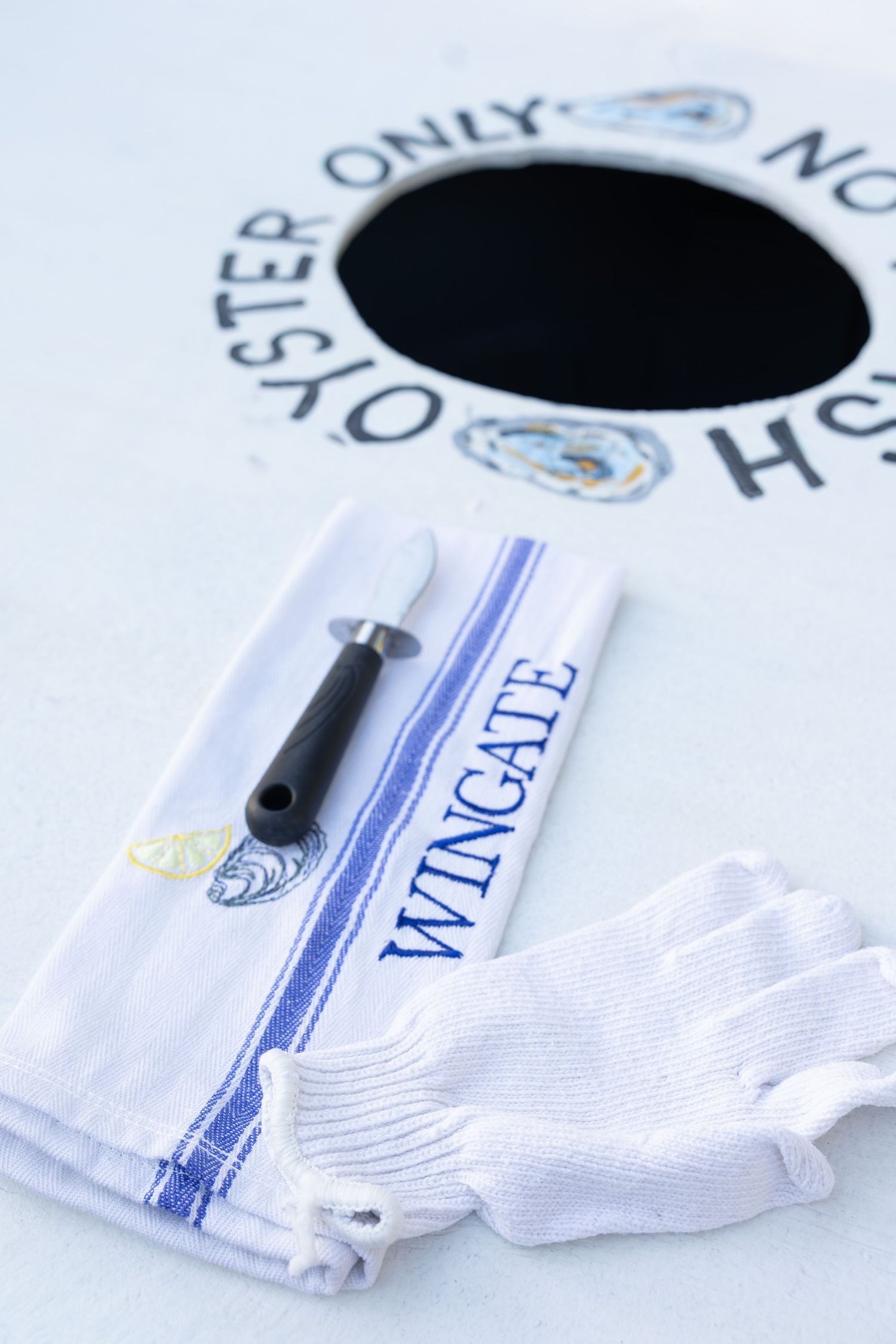 White athletic socks with blue and gold embroidered logos laid out in a row on a white surface.