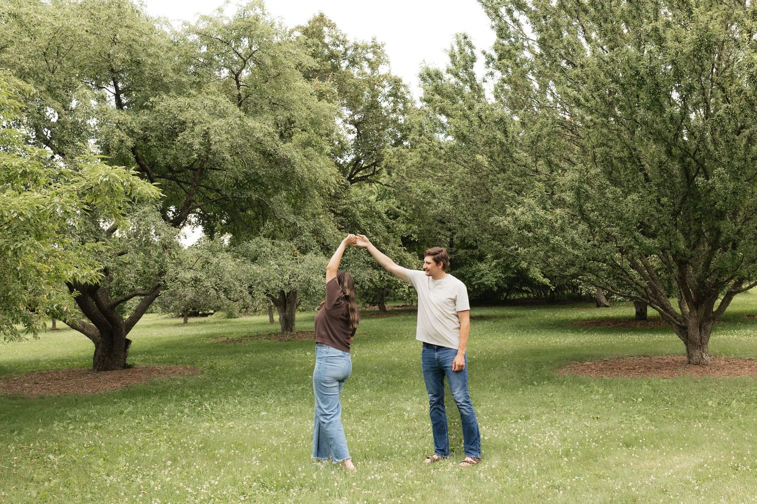 People walking and playing in a green park setting on a sunny day.