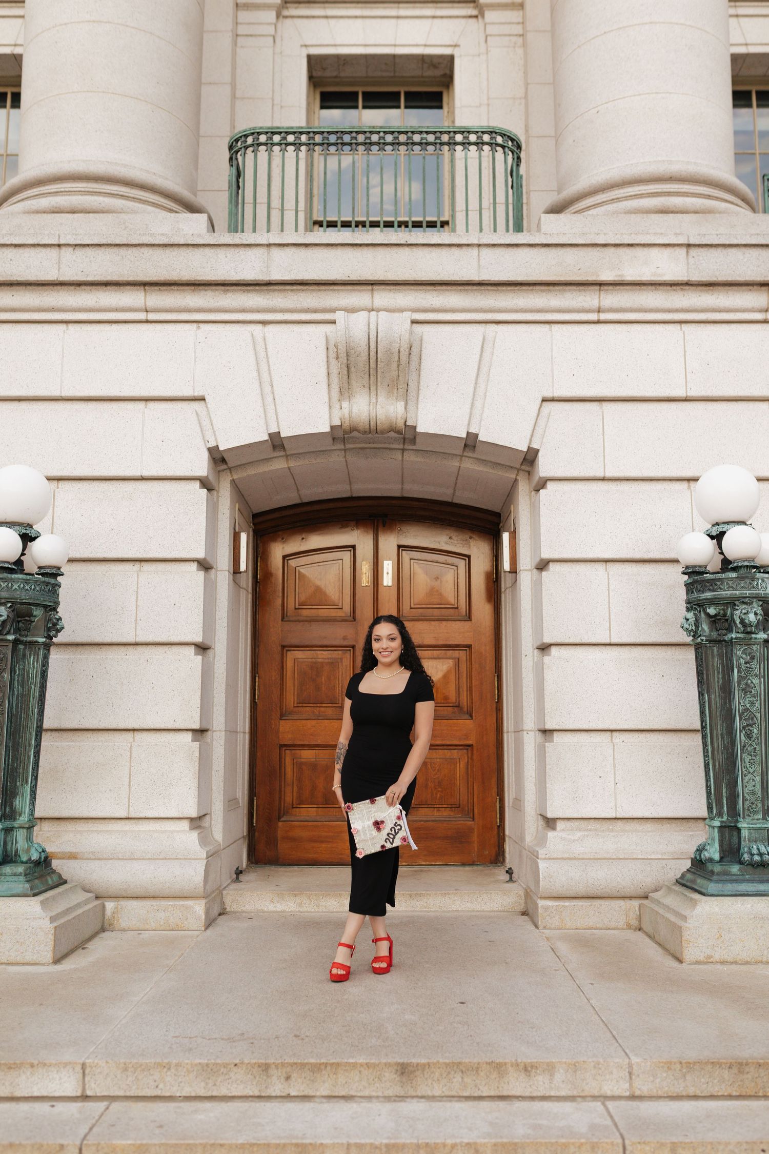 Series of architectural shots showing graduate against ornate wooden doors and columns.