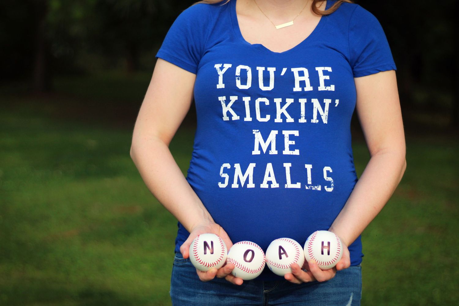 A blue t-shirt with 'You're Kickin' Me Smalls' text displays baseballs spelling out NOAH.