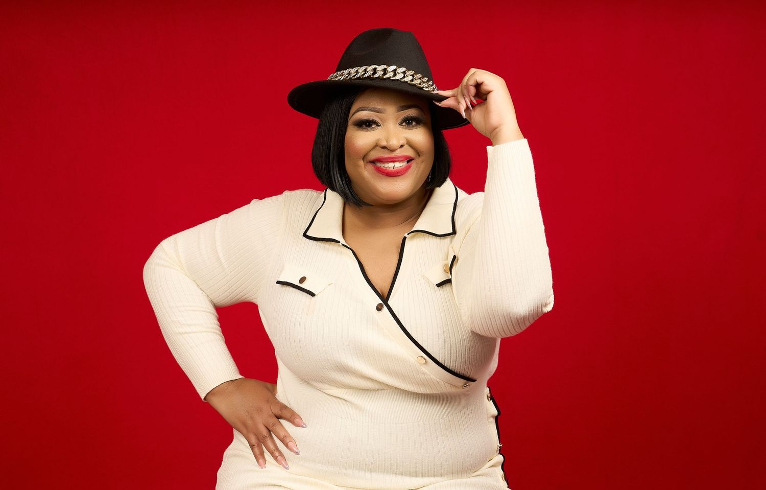 A figure in a white dress with black trim poses against a vibrant red background in a series of dynamic shots.