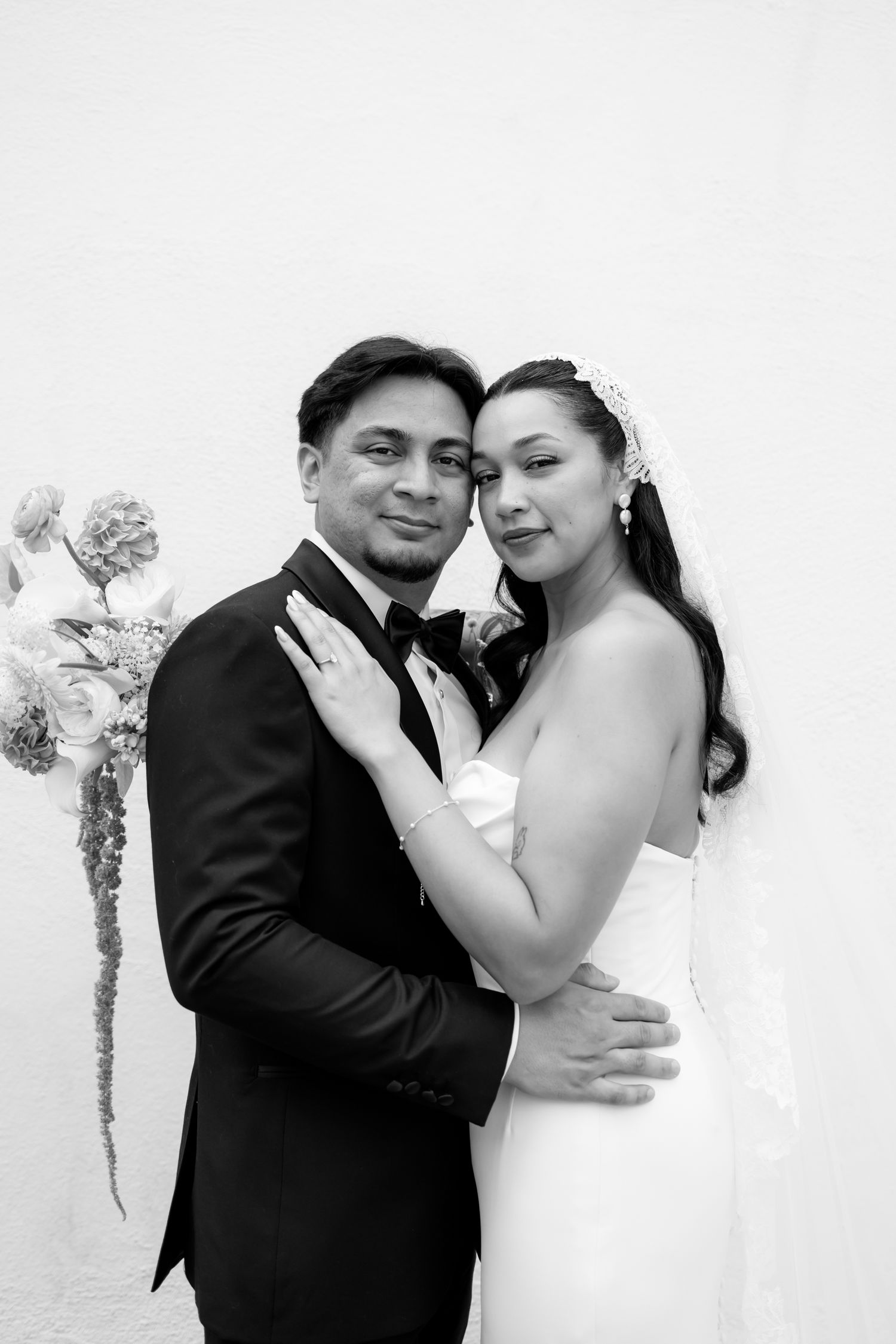 A romantic black and white wedding photo series showing tender moments between a bride and groom.