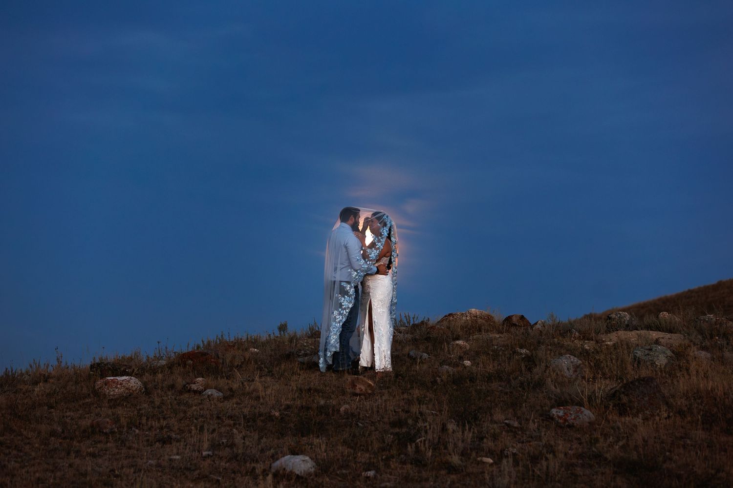 Bride and Groom share intimate moment in the Montana moonlight taken by Missoula Wedding Photographer Shawn Strasburg