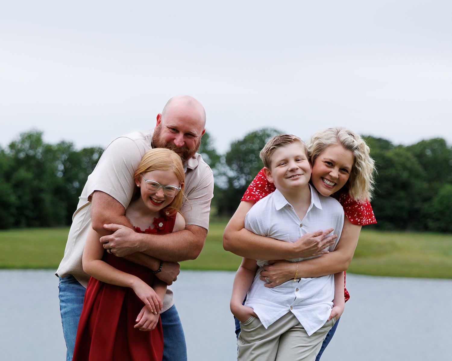 Family Photo with Mom, Dad, and two children laughing taken by local Missoula photographer Shawn Strasburg