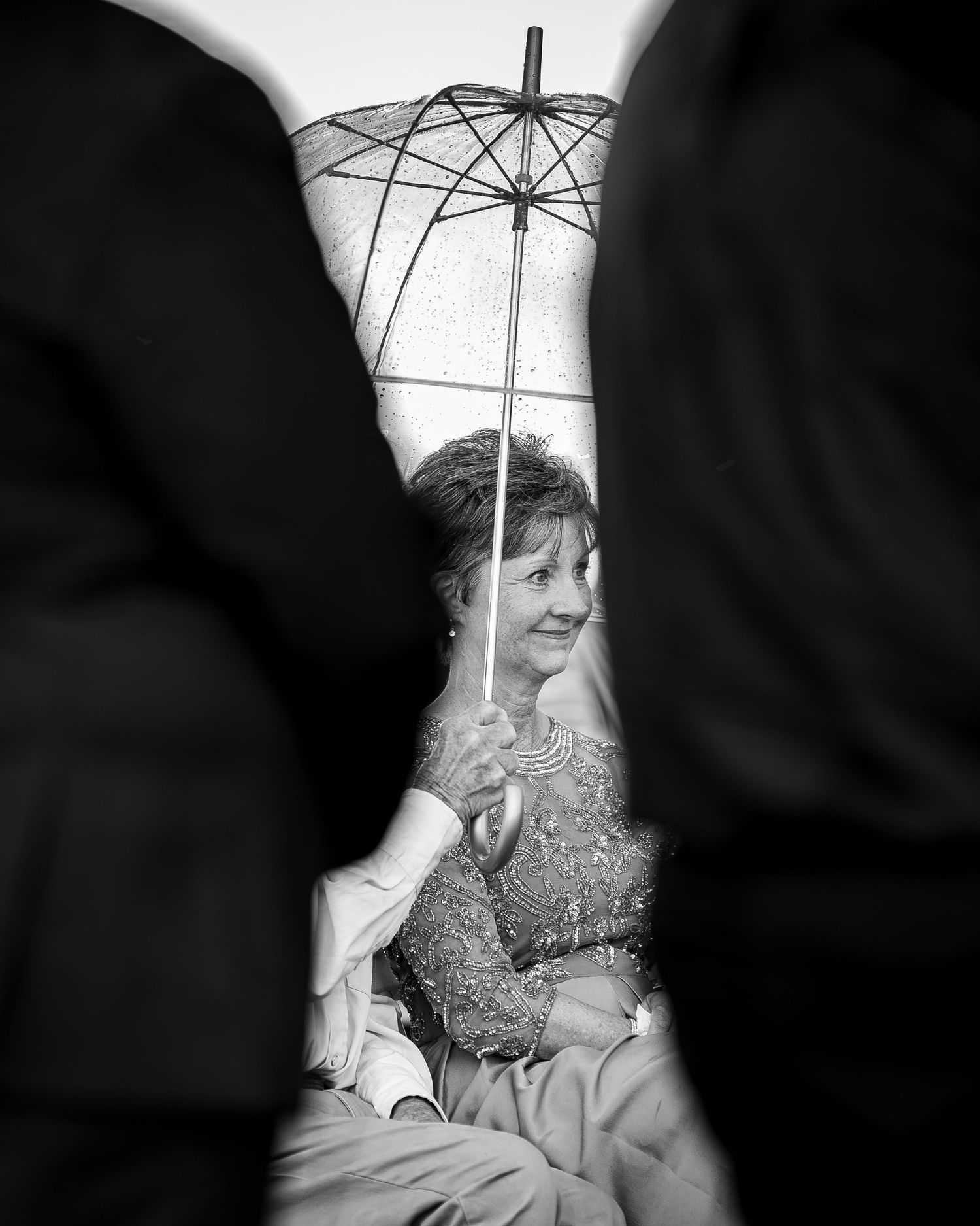 A sequence of black and white photographs showing a figure holding an umbrella in different poses.