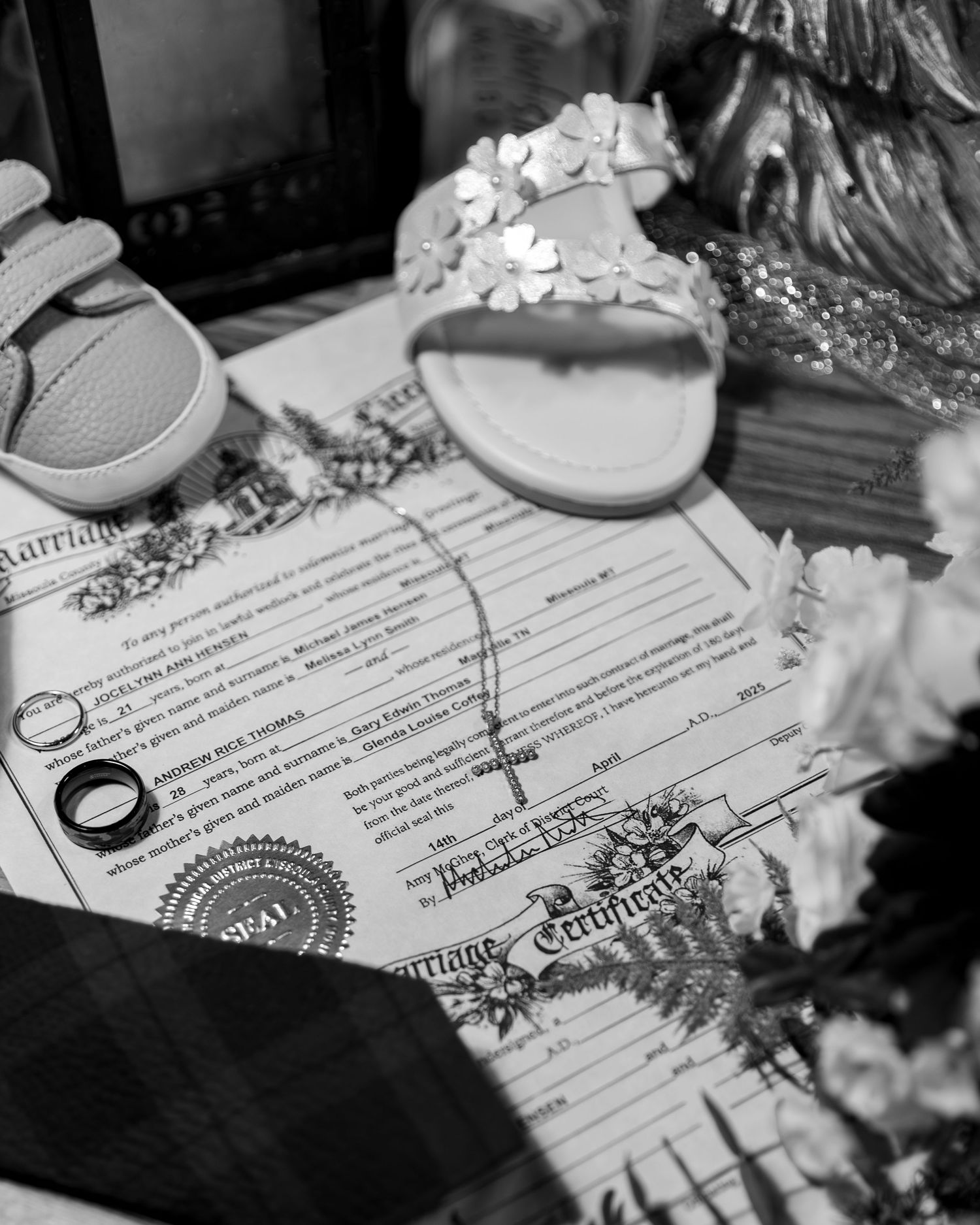 Black and white image shows a marriage certificate document with signatures and text visible on paper.