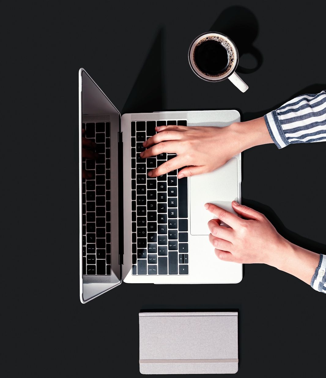 A hand interacts with laptop touchpad and keyboard against dark background showing different angles of computer usage.