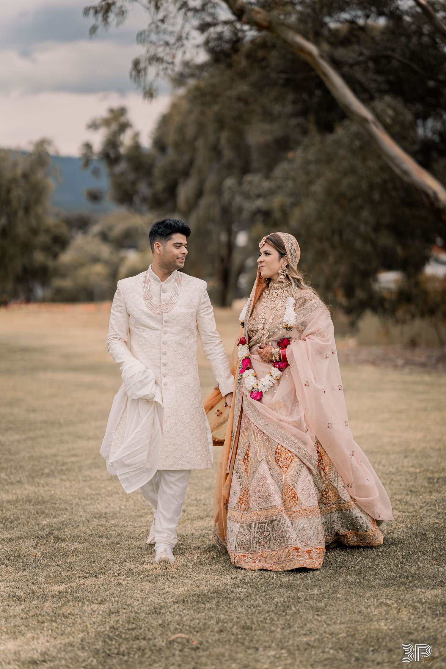Bride and groom sharing a romantic moment in a scenic outdoor setting, captured in a timeless wedding portrait.