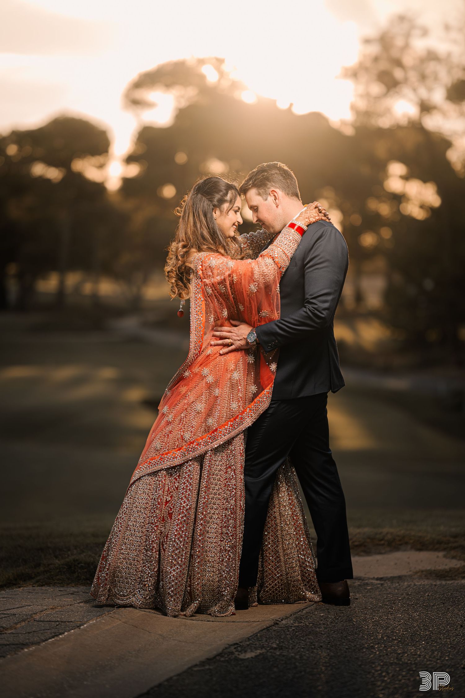 Close-up portrait of the bride and groom embracing, radiating love and joy against a soft, blurred background.