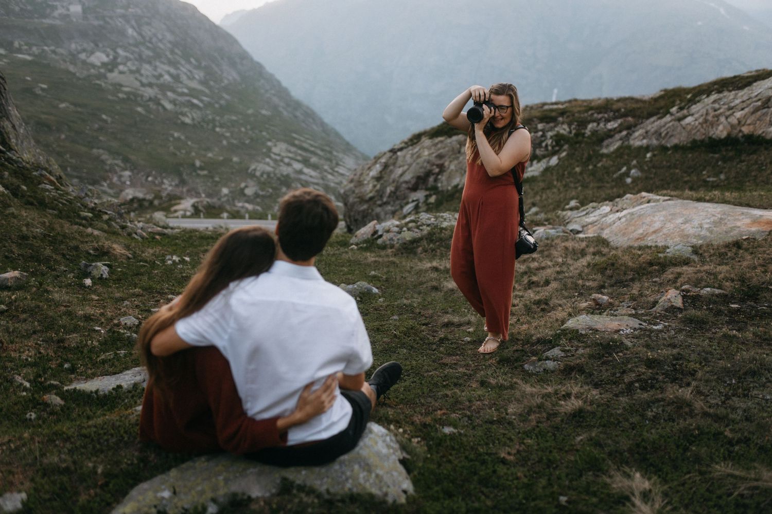 Photography session in mountains with red dress and casual white outfit.
