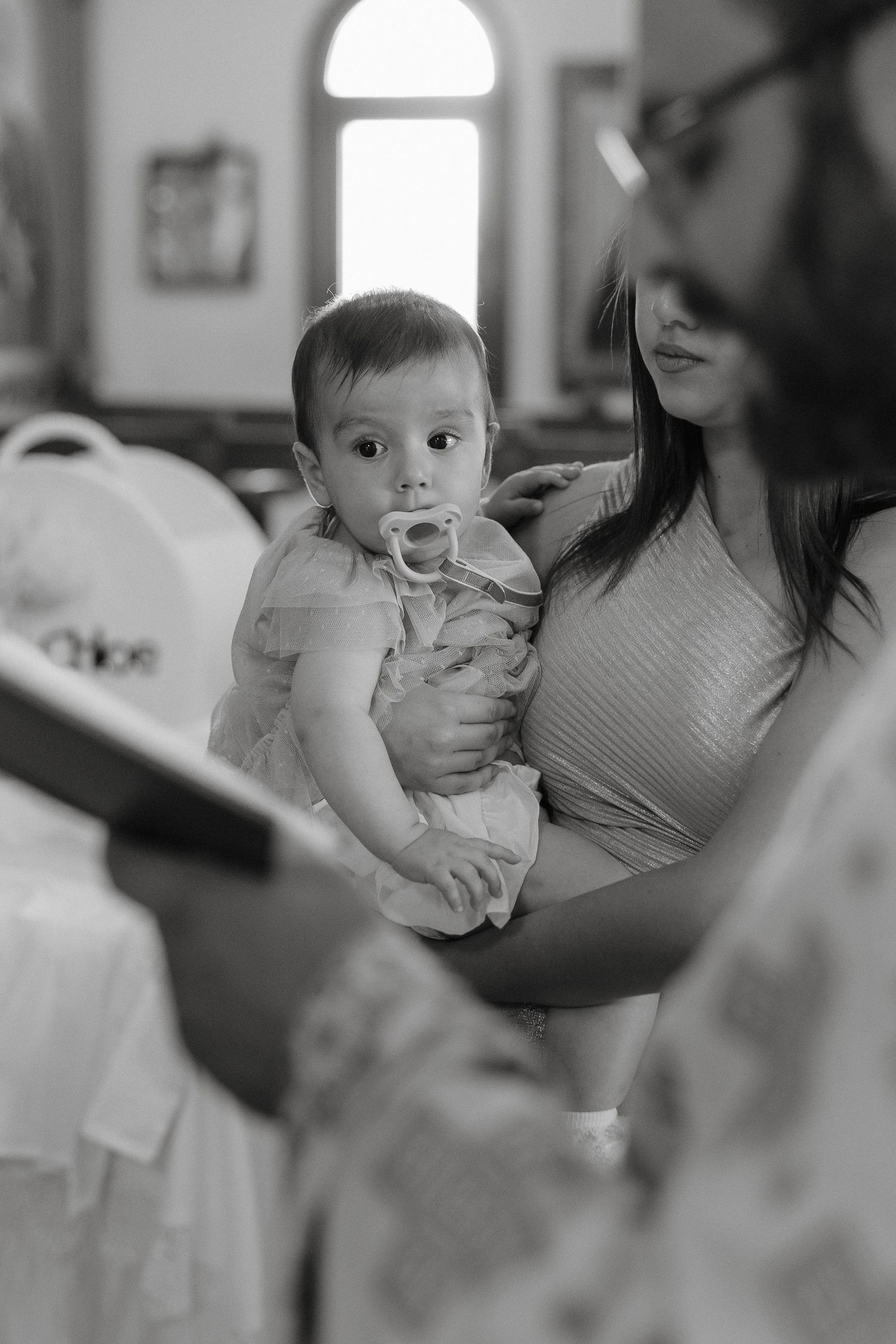 Christening photography in Paphos by a professional photographer capturing the baby during a baptism service.