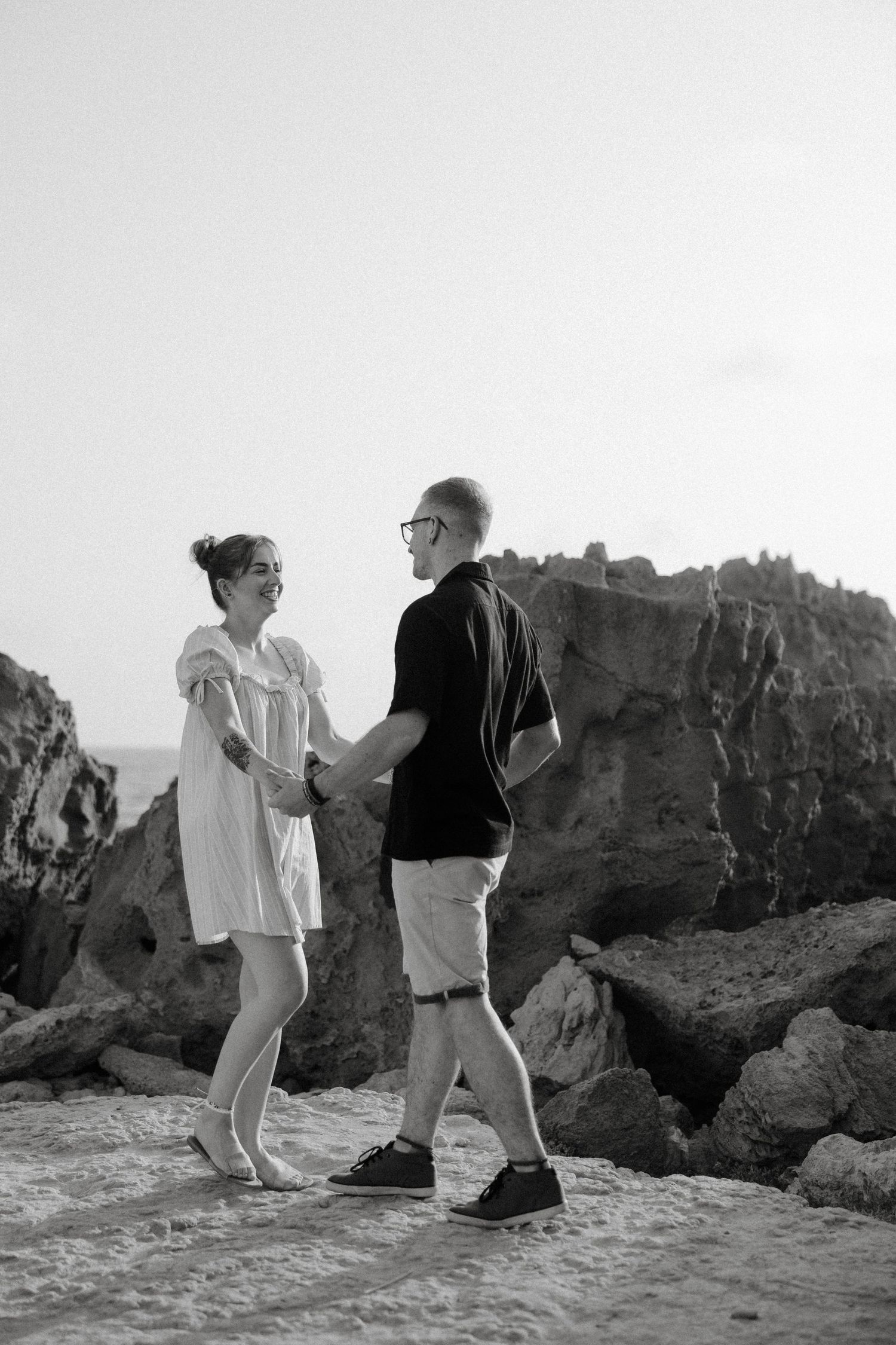 Couples photoshoot in Paphos captured by the best photographer when the couple is playing joyfully front of the camera.