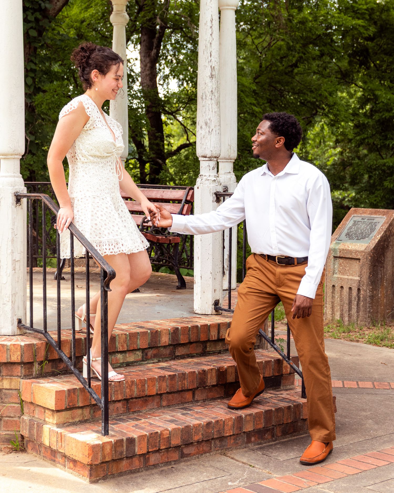 A sequence of photos showing a couple playfully interacting on brick steps with white columns in a garden setting.