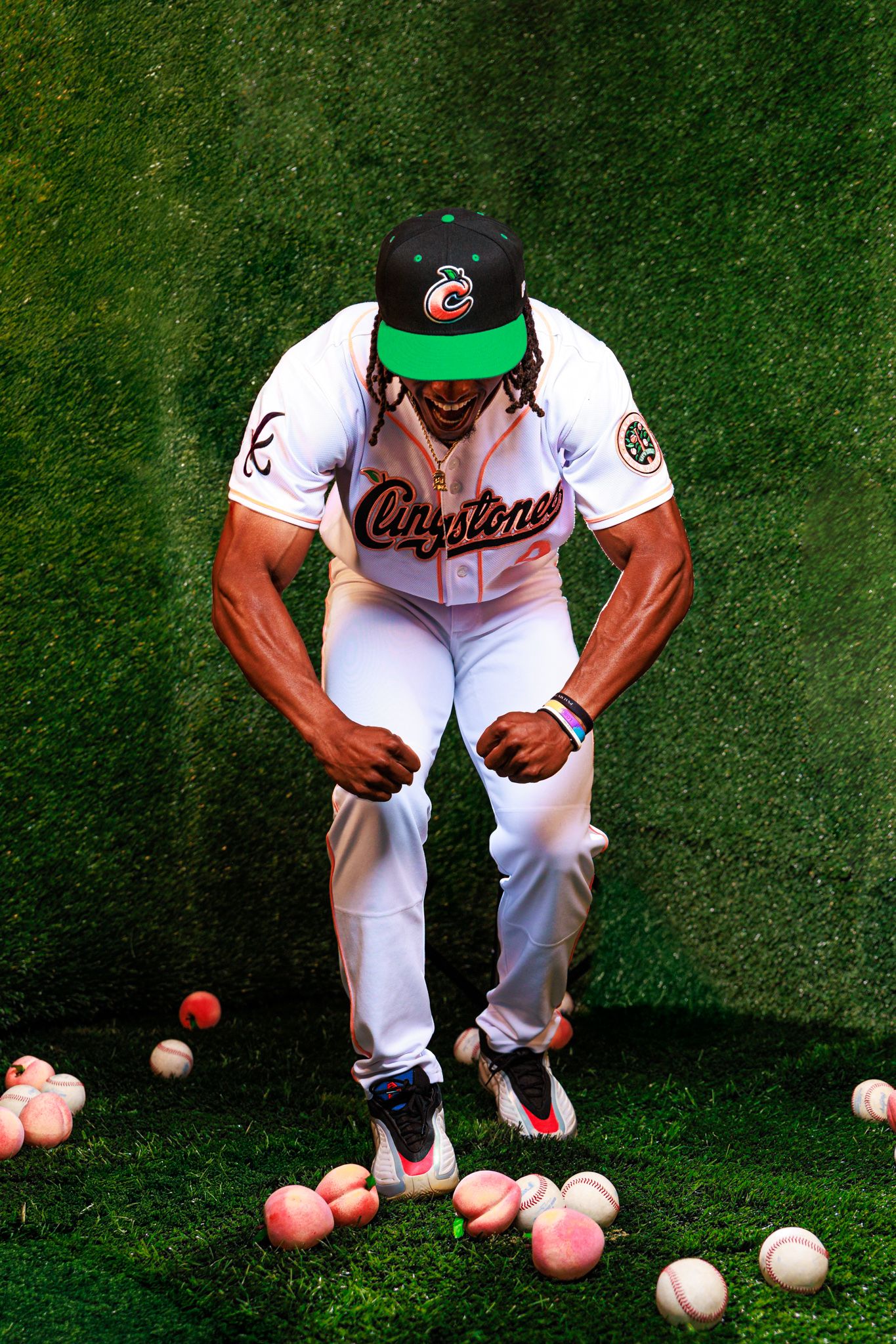 Baseball player in Claystone uniform flexing on grass field surrounded by scattered baseballs and peaches.