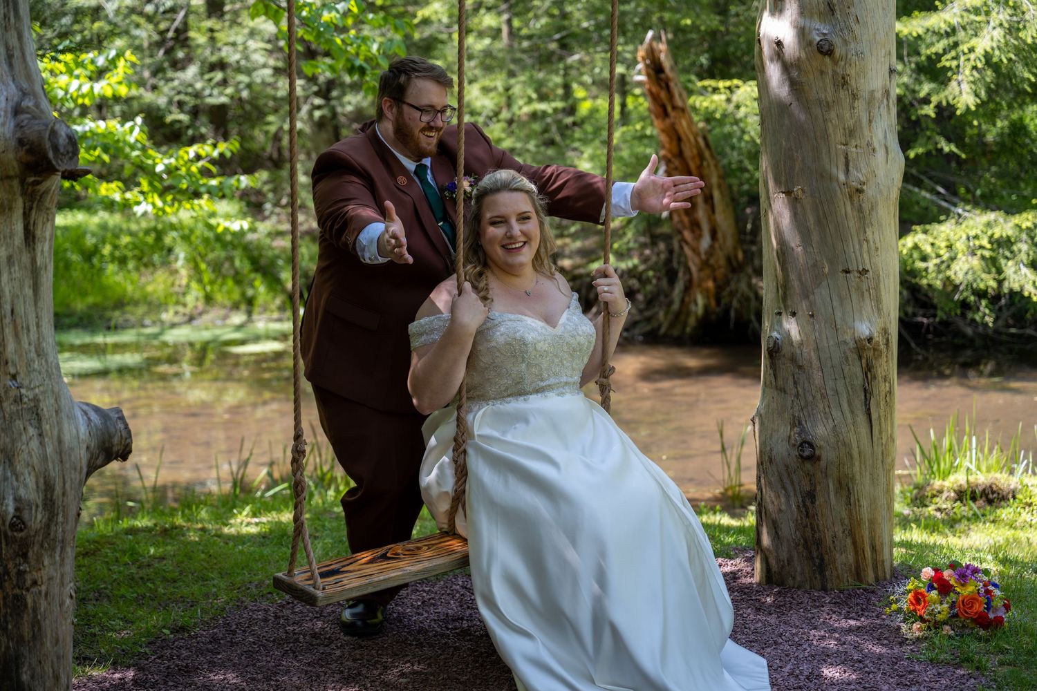 Wedding celebration candid moments captured in a rustic wooded outdoor venue.