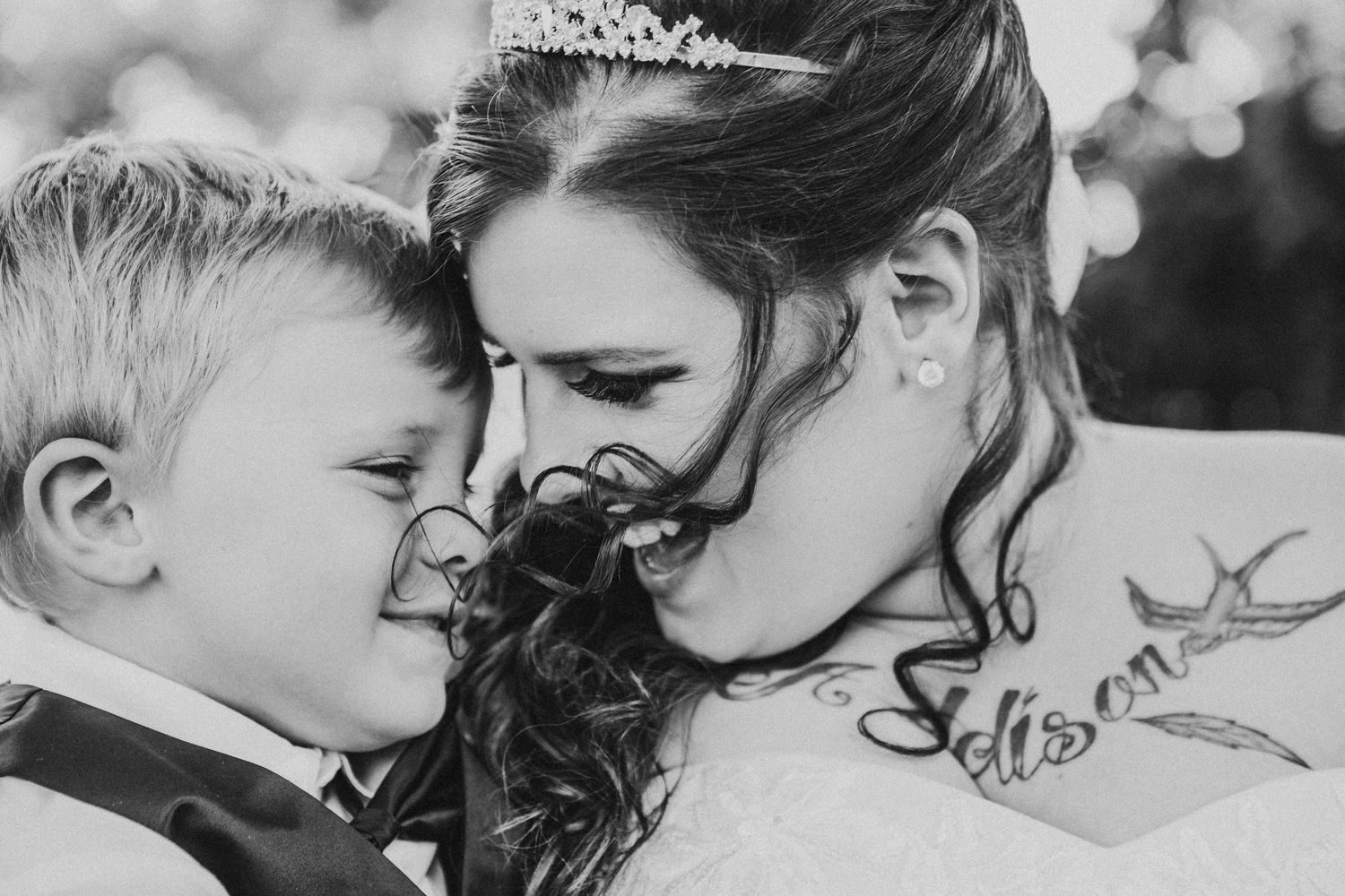 Bride on her wedding day with her sun with the light shining through the trees summer wedding south carolina in black an