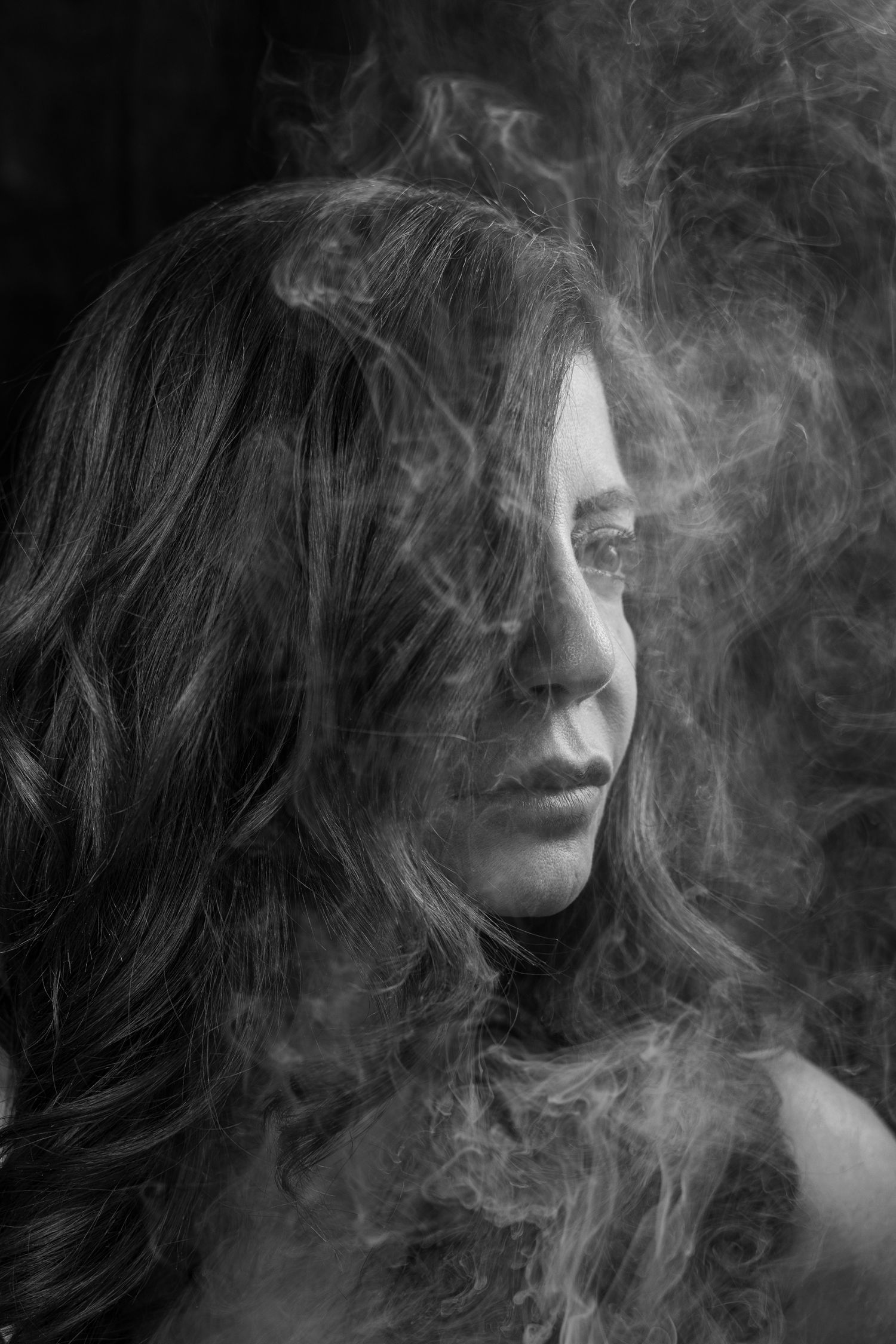 Black and white self-portrait  - surrounded by smoke, moody and expressive fine art photography.