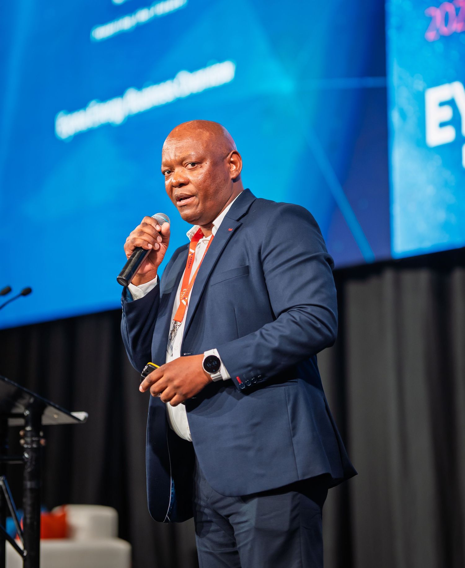 Professional speaker addresses audience at 2025 Eyona Energy Retailer Conference on stage.