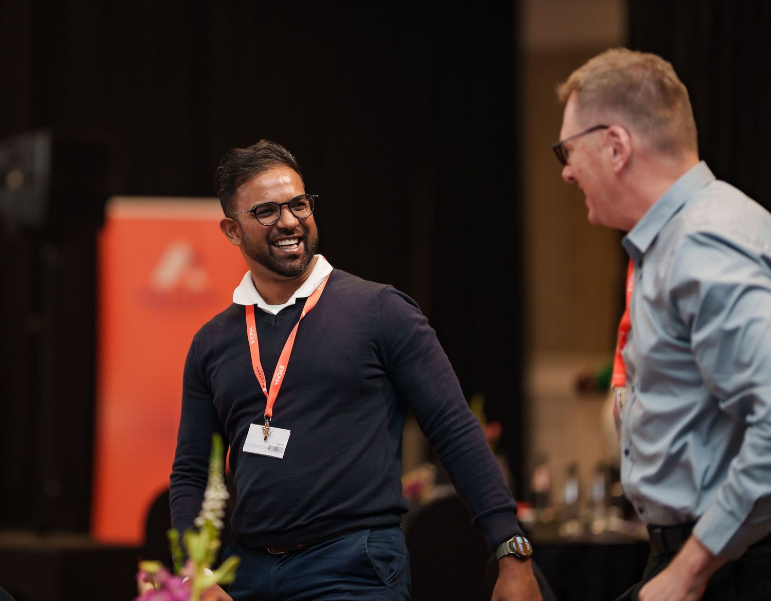 Two men share a laugh at an Astron Energy corporate networking event.