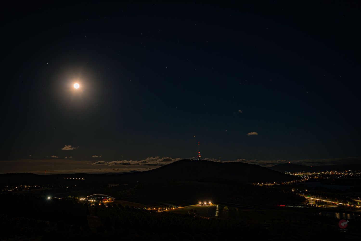 Moonrise sequence over mountains showing the progression from darkness to moonlit landscape.