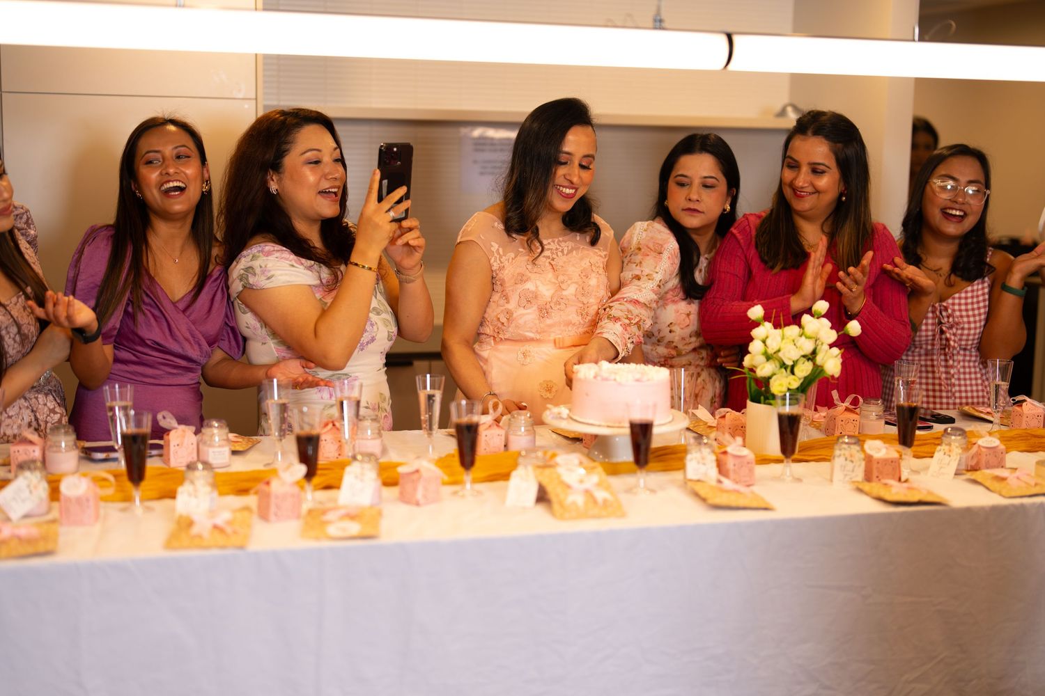 Group celebration photos showing people gathered at a long table with drinks and food.