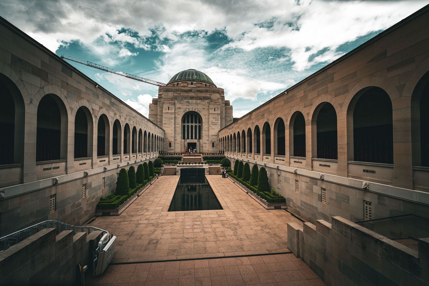Symmetrical view of the Australian War Memorial with its long colonnade leading to the main building.