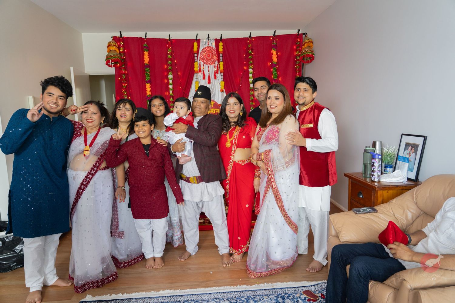 Traditional celebration gathering with guests wearing red and white attire.