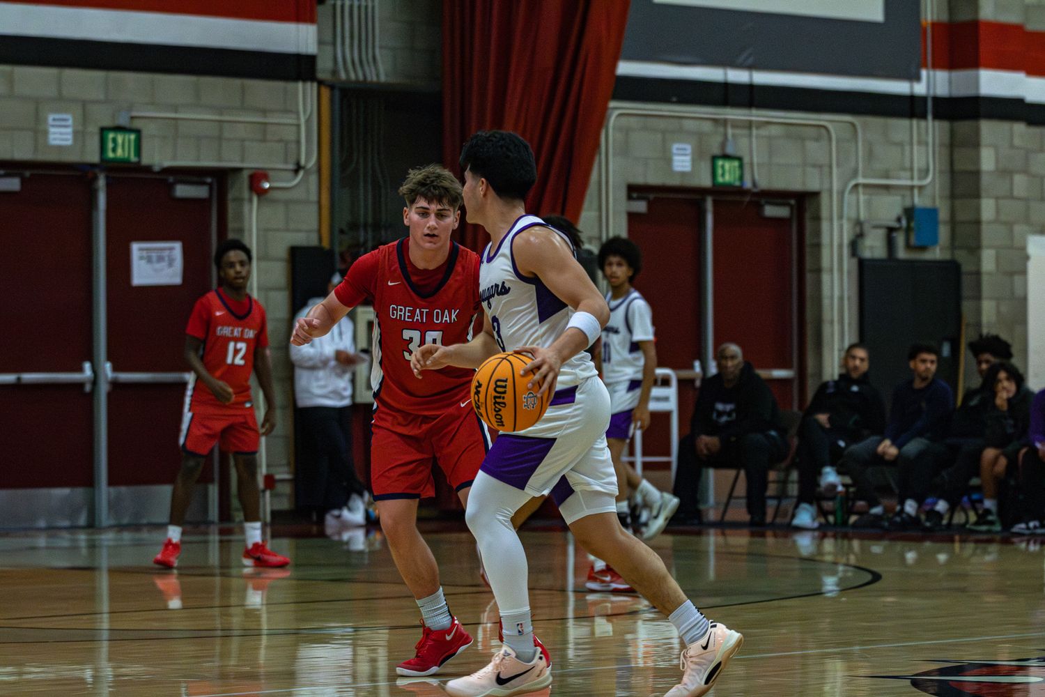 One-on-one basketball defense during game action.