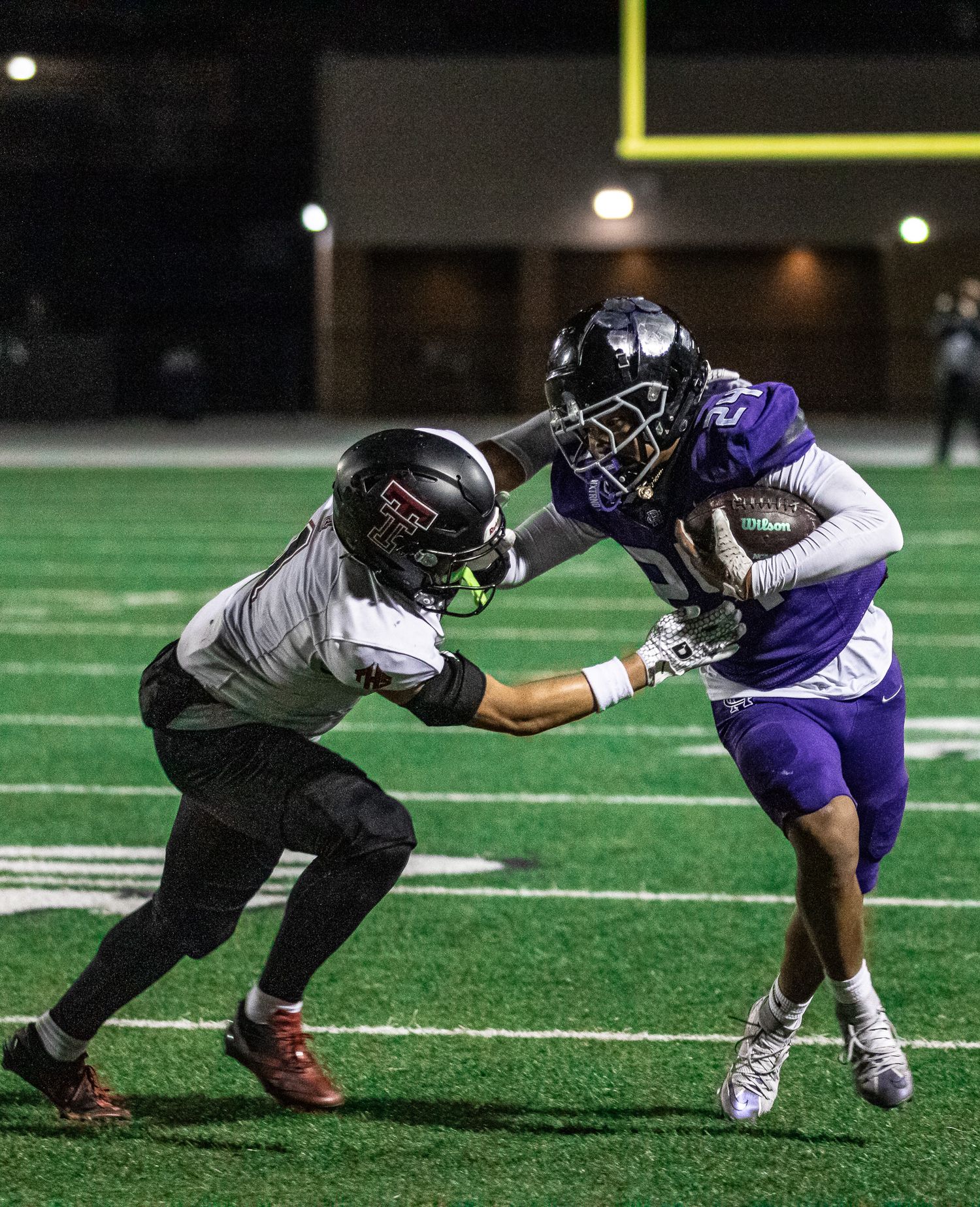 Football tackle attempt during high school game action.