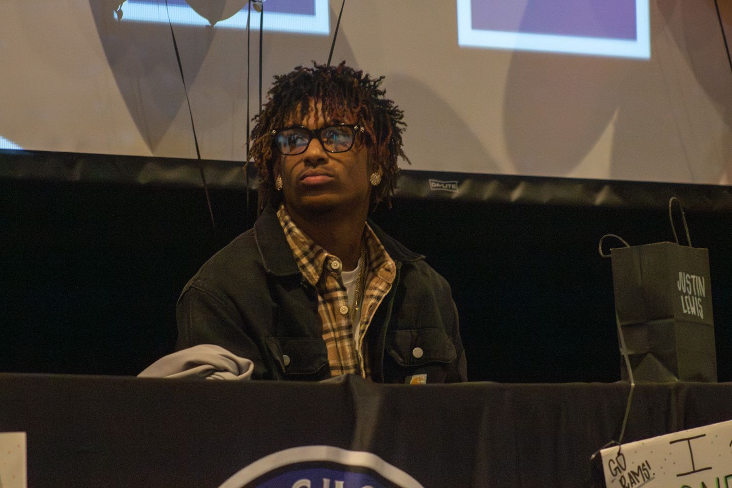 High school athlete during signing day college commitment ceremony.