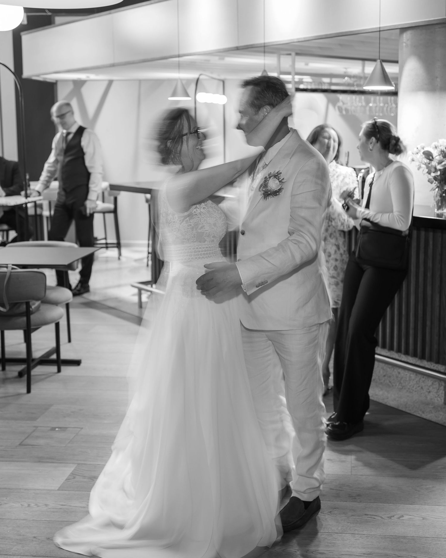 Black and white sequence of a couple's first dance at their wedding reception showing graceful movements and spins.