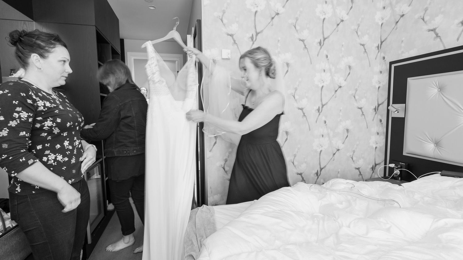 A black and white photo collage shows a series of wedding moments with dancing, celebration and cake cutting.