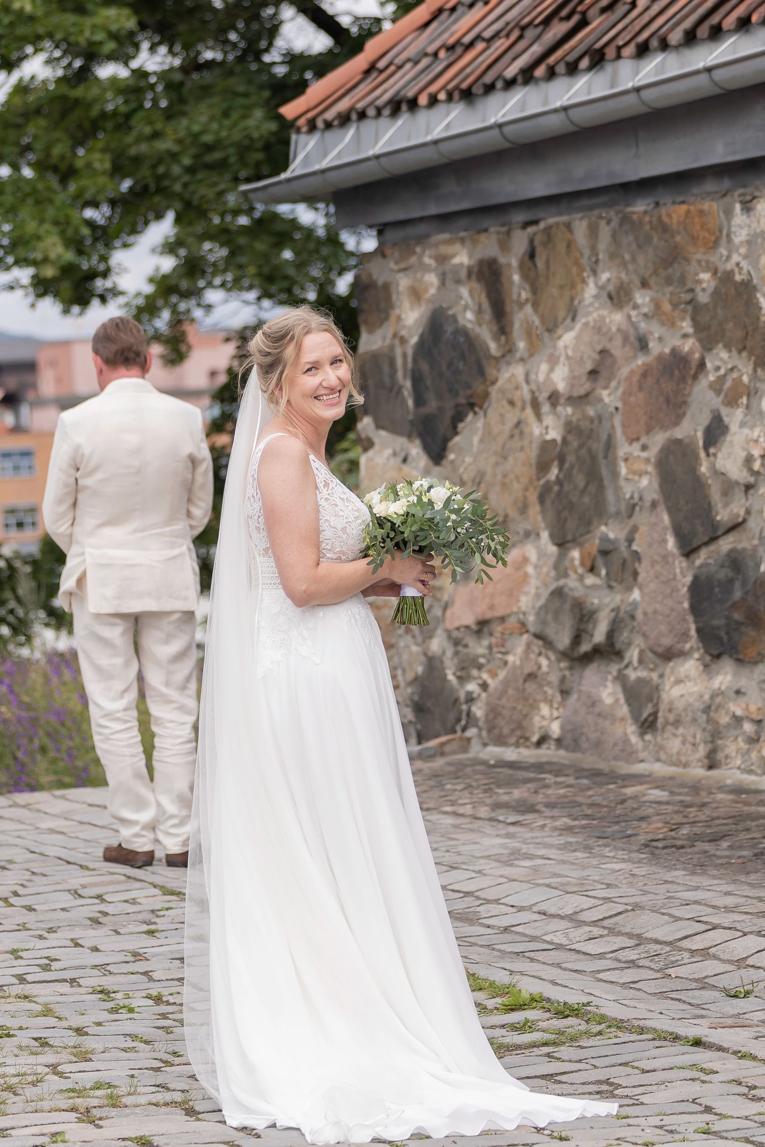 Wedding photo sequence showing a first look moment against a stone wall backdrop.