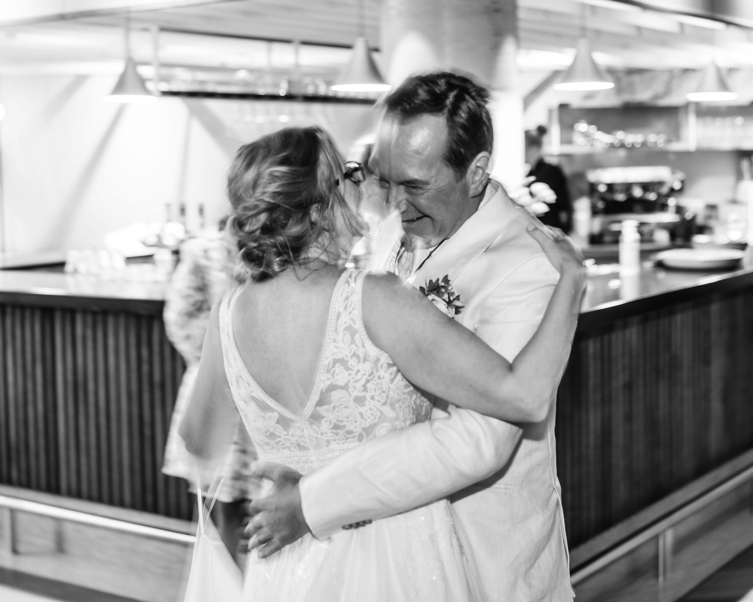 Romantic dance sequence showing tender moments between newlyweds in black and white photography.