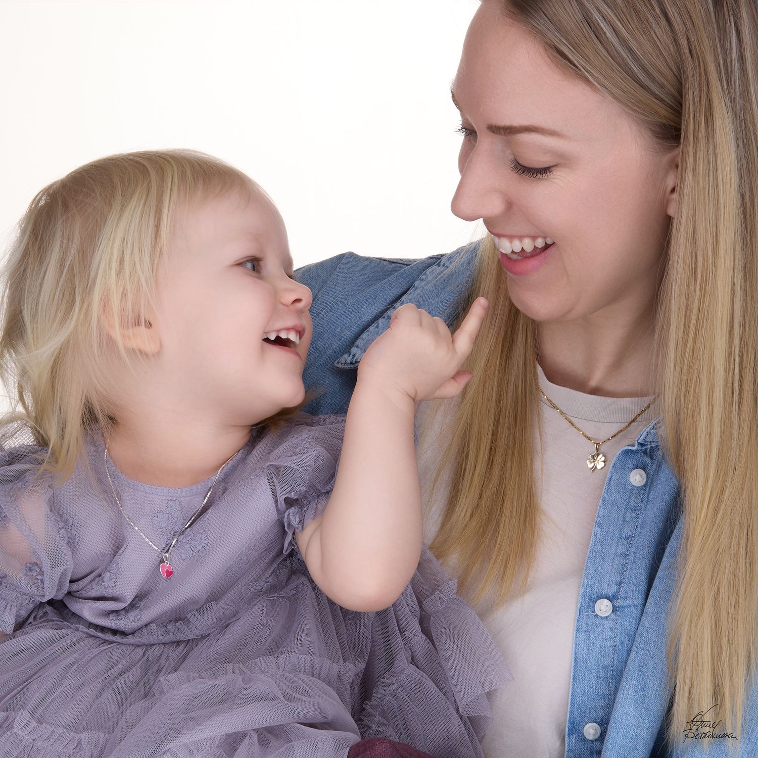 Candid mother-daughter moment showing playful interaction and laughter.