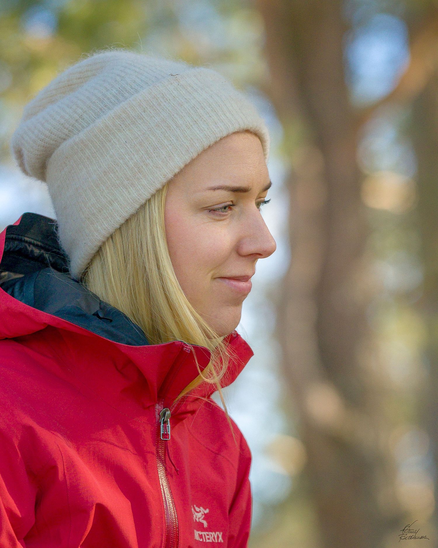 Outdoor portrait series featuring someone in a red jacket and beanie hat among trees.