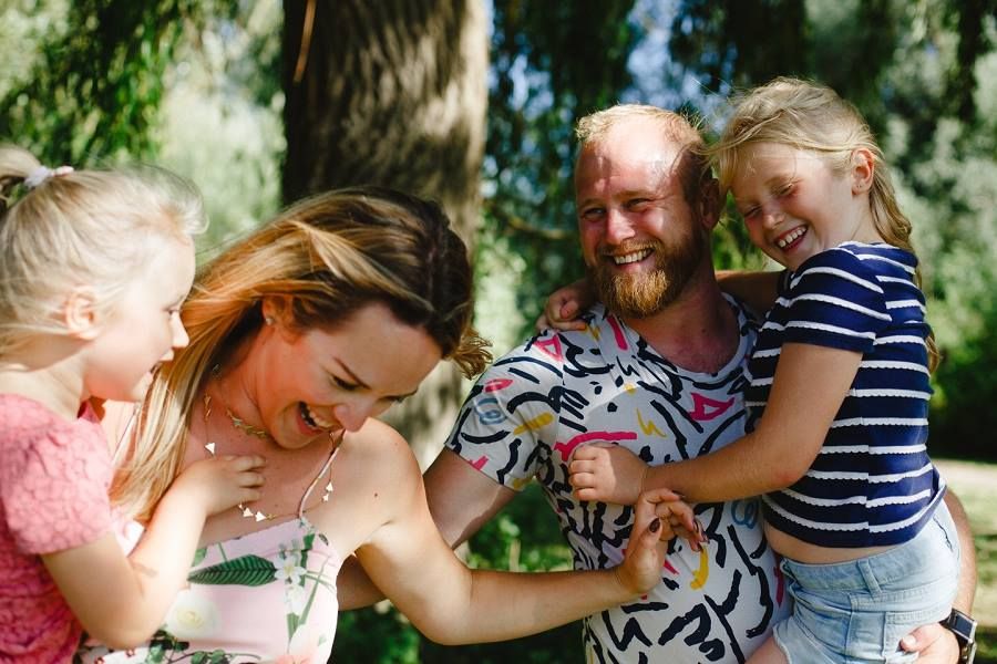 Joyful family moment captured outdoors on a sunny day.