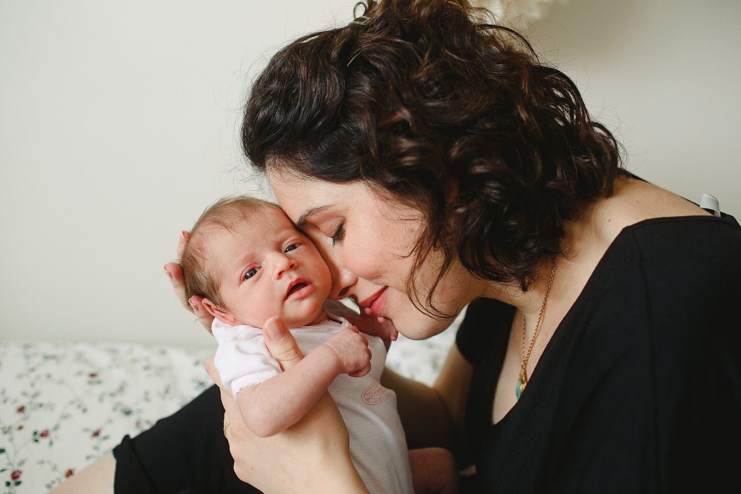 An intimate moment shared between parent and baby during a lifestyle photography session.