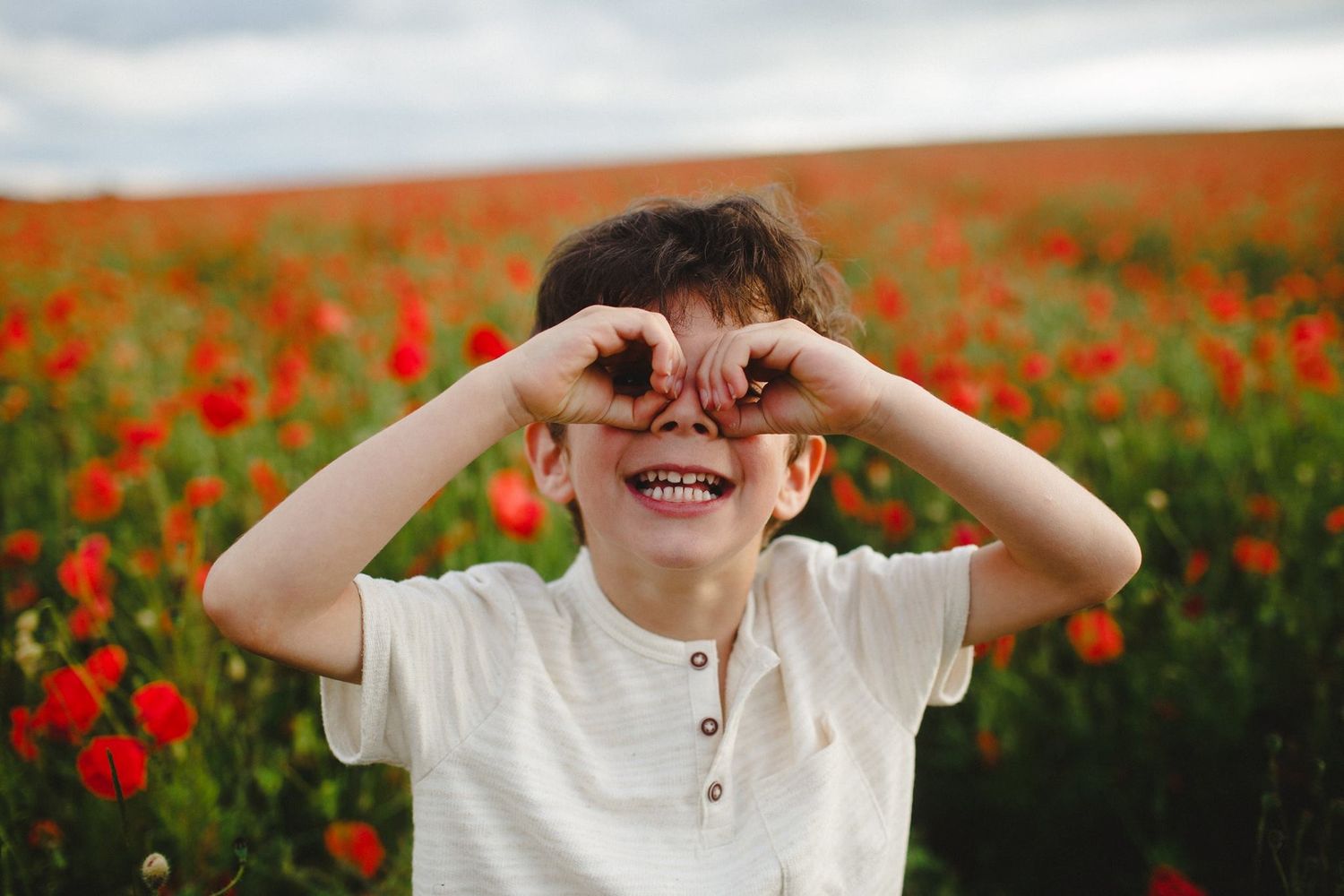 Joyful moments captured in a vibrant red poppy field during golden hour sunset.