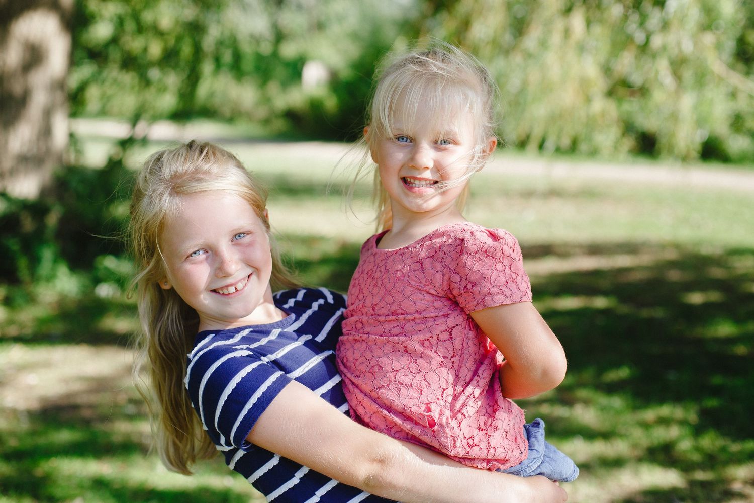 A series of candid outdoor family photos showing joyful moments and laughter in a sunny garden setting.