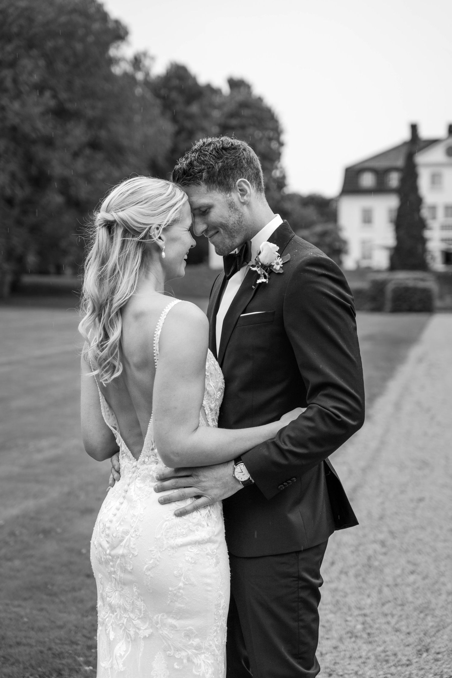 Elegant black and white wedding photos showing tender moments between newlyweds.