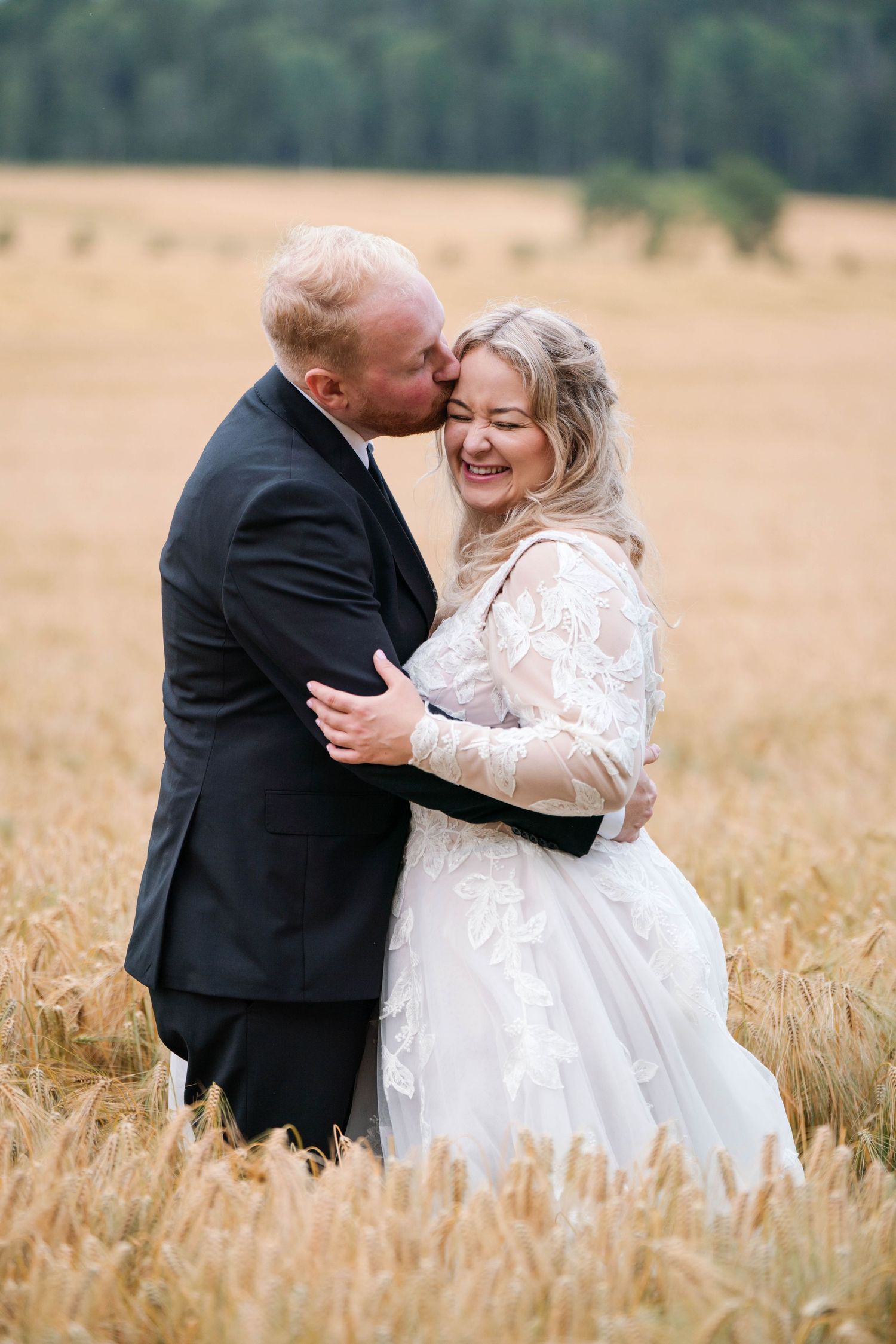 Joyful wedding moments photographed in a rustic wheat field setting.