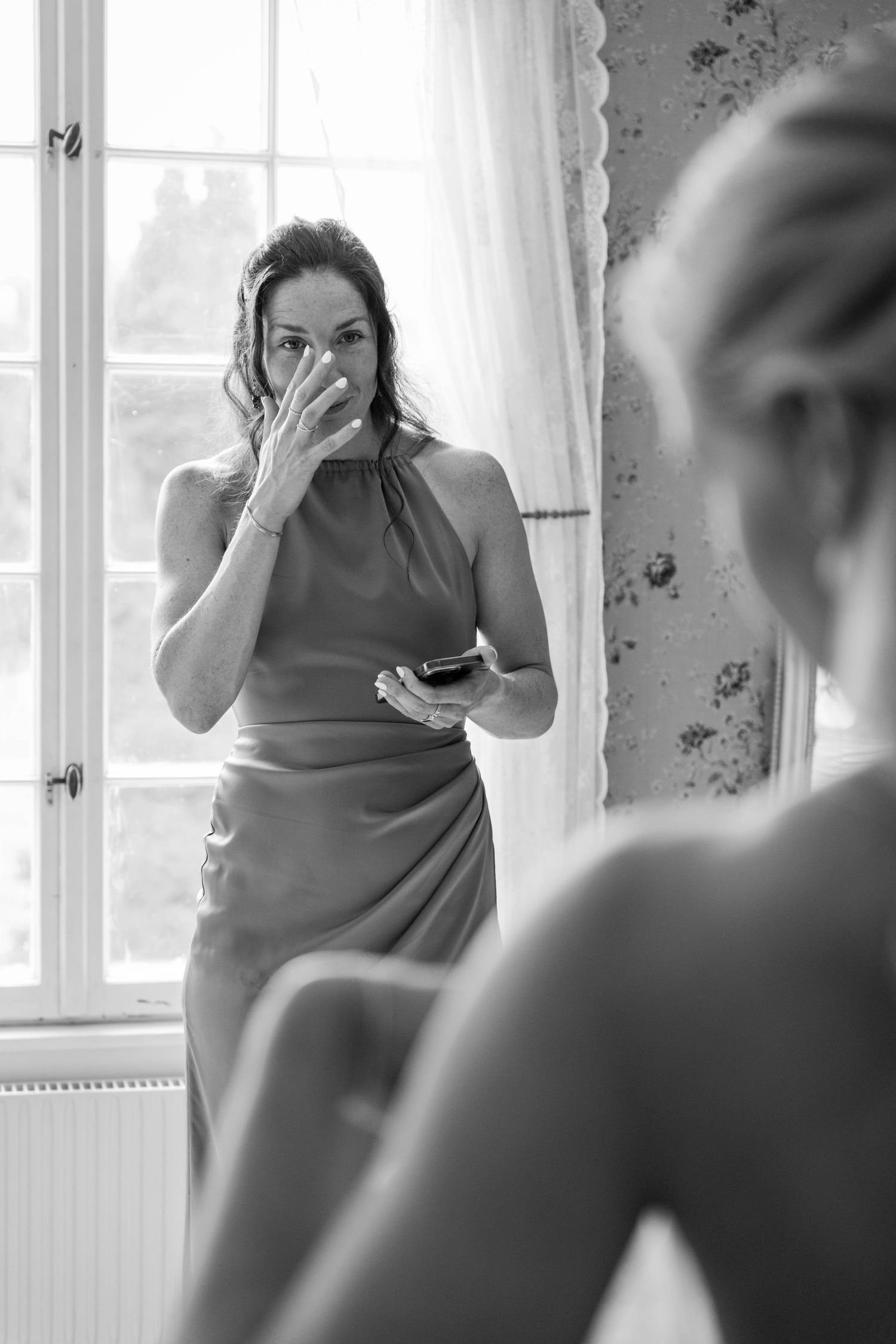 Black and white series showing preparations in an elegant room with natural window light.